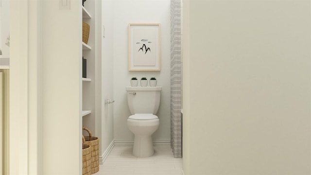 bathroom featuring toilet and baseboards