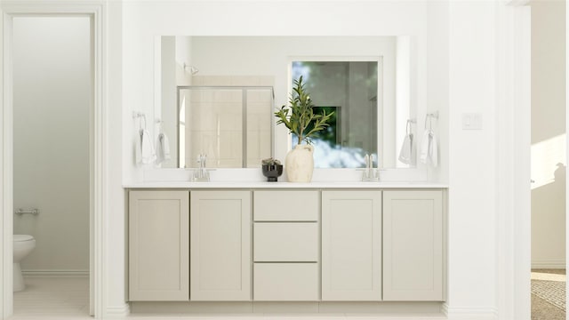 full bathroom featuring double vanity, baseboards, toilet, a shower stall, and a sink