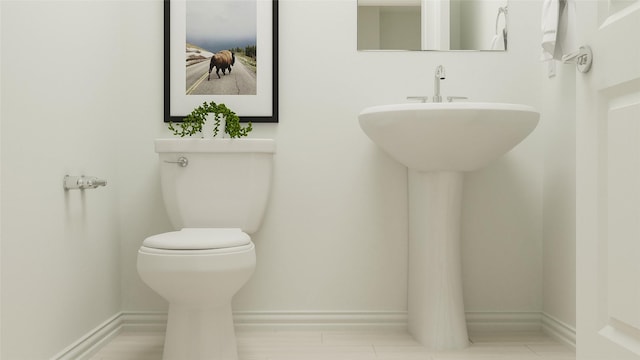 bathroom featuring baseboards and toilet