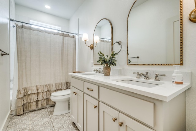 full bathroom with double vanity, shower / bath combo, a sink, and toilet