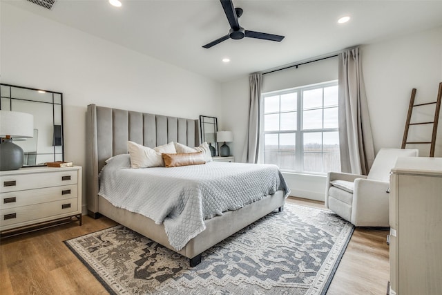 bedroom with wood finished floors, a ceiling fan, and recessed lighting