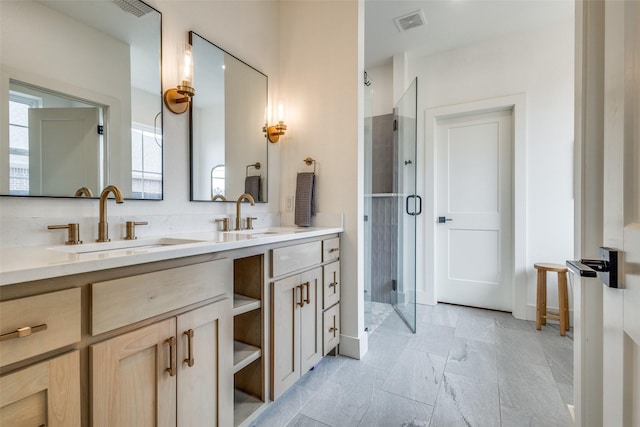 full bath featuring double vanity, a stall shower, a sink, and visible vents