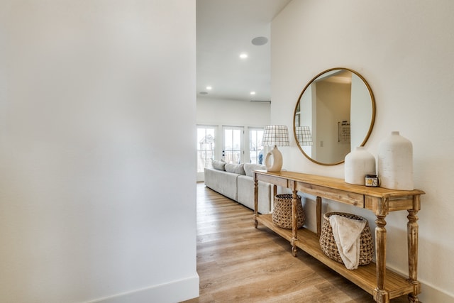 hallway with light wood finished floors and recessed lighting