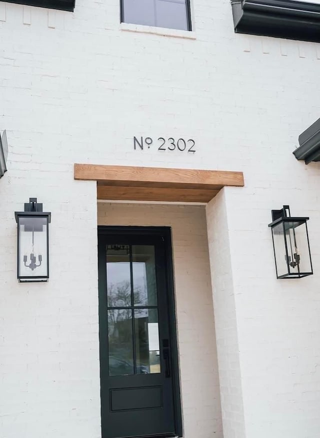 property entrance featuring brick siding