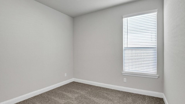 unfurnished room featuring carpet flooring and baseboards