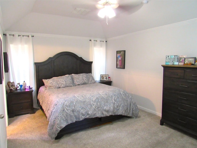 bedroom featuring crown molding, lofted ceiling, light colored carpet, visible vents, and baseboards