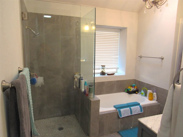 full bathroom featuring a stall shower, a garden tub, and vanity