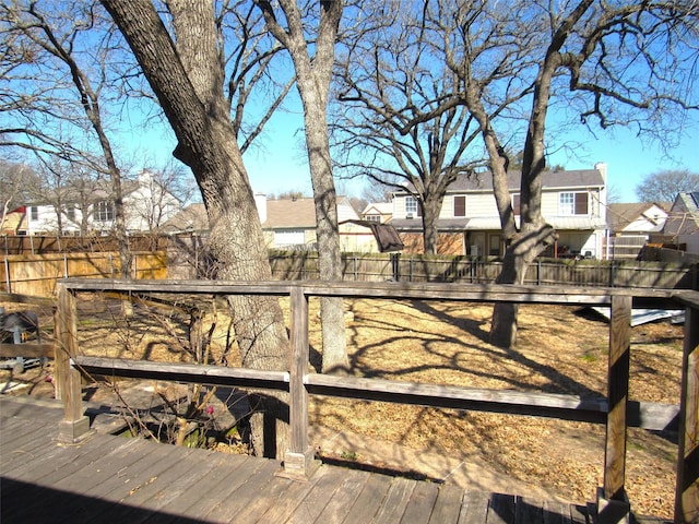 wooden deck with a residential view and fence