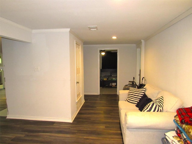 hallway with dark wood-style flooring, visible vents, crown molding, and baseboards