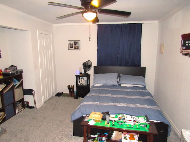 carpeted bedroom featuring ceiling fan and ornamental molding