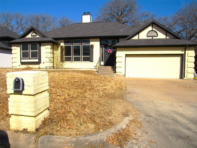 single story home with roof with shingles, brick siding, a chimney, concrete driveway, and a garage