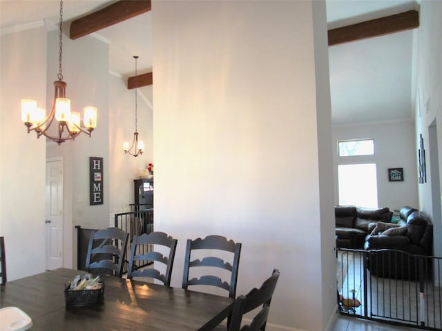 dining space with high vaulted ceiling, ornamental molding, beam ceiling, and a notable chandelier