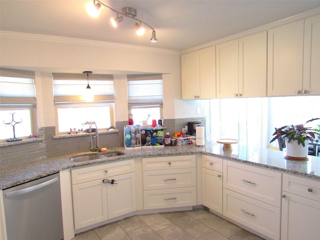 kitchen with a sink, white cabinetry, hanging light fixtures, stainless steel dishwasher, and light stone countertops