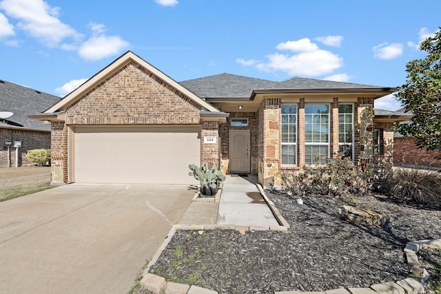 view of front of house featuring an attached garage, driveway, roof with shingles, and brick siding