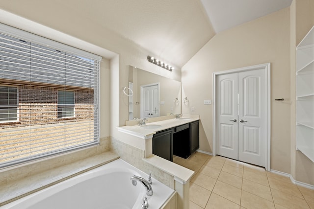 bathroom with lofted ceiling, tile patterned flooring, a garden tub, a closet, and double vanity