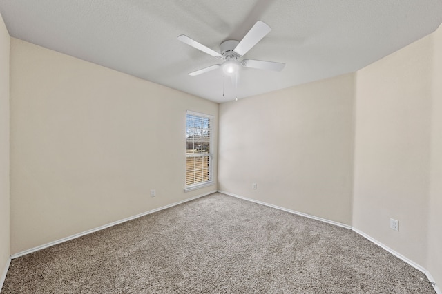 unfurnished room with carpet floors, ceiling fan, a textured ceiling, and baseboards