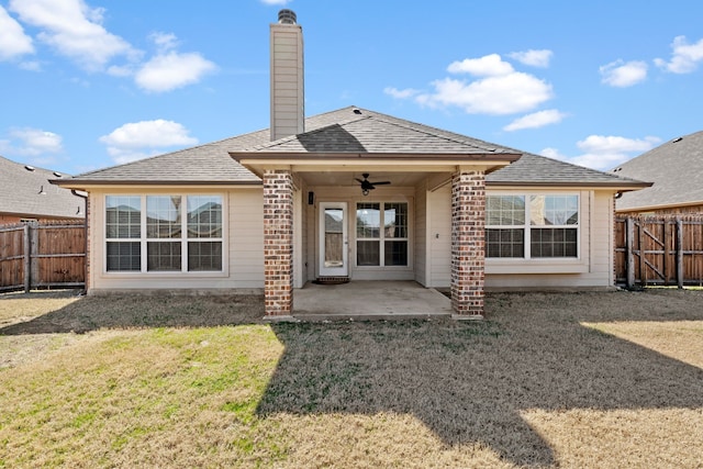 rear view of property featuring a chimney, fence, a patio, and ceiling fan