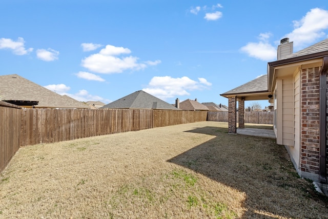 view of yard featuring a fenced backyard and a patio