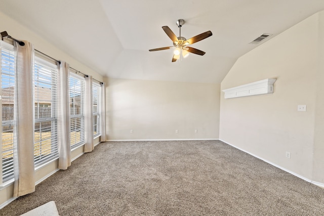 unfurnished room featuring visible vents, baseboards, vaulted ceiling, a ceiling fan, and carpet