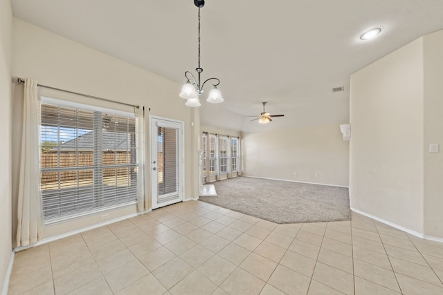 unfurnished room featuring light carpet, light tile patterned floors, visible vents, baseboards, and ceiling fan with notable chandelier