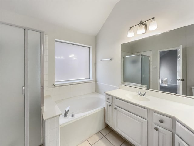 bathroom with a shower stall, a garden tub, vaulted ceiling, tile patterned floors, and vanity