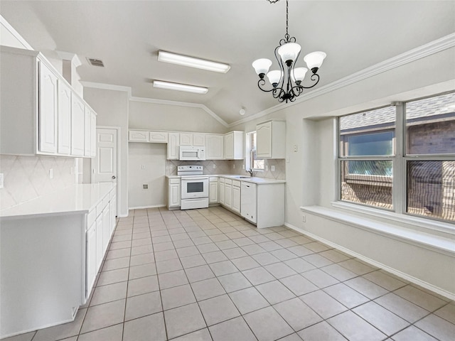 kitchen with a sink, white appliances, light tile patterned flooring, white cabinets, and lofted ceiling