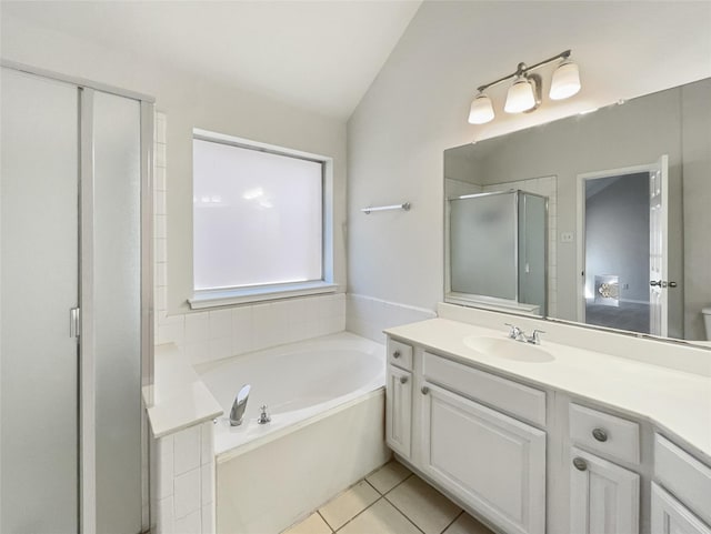 full bathroom with tile patterned flooring, a shower stall, a garden tub, and vanity