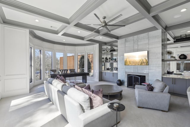 carpeted living room featuring beamed ceiling, coffered ceiling, a high end fireplace, and crown molding