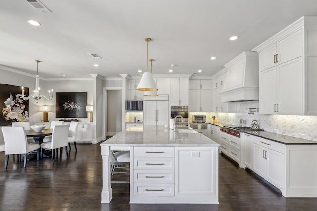 kitchen featuring visible vents, white cabinets, decorative backsplash, appliances with stainless steel finishes, and custom exhaust hood