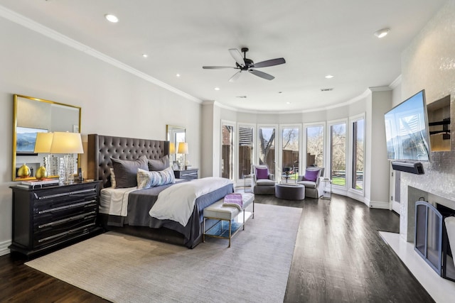 bedroom featuring baseboards, a fireplace with flush hearth, ornamental molding, wood finished floors, and recessed lighting