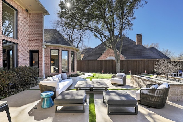 view of patio / terrace with outdoor lounge area and fence