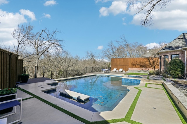 view of swimming pool with an in ground hot tub, a patio area, a fenced backyard, and a fenced in pool