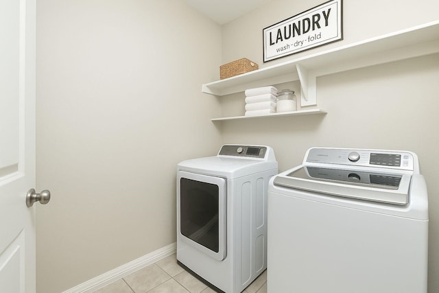 1805 Ringtail Dr, Little Elm, TX 75068 - clothes washing area featuring washer and clothes dryer, light tile patterned floors, and baseboards