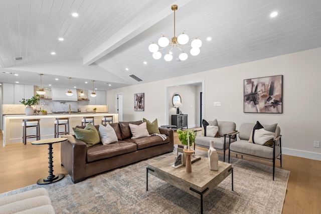 living room featuring vaulted ceiling with beams, recessed lighting, light wood-style flooring, wooden ceiling, and baseboards