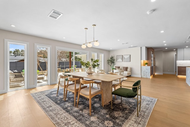 dining room with light wood-type flooring, visible vents, baseboards, and recessed lighting