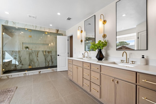 full bathroom featuring double vanity, a marble finish shower, visible vents, and a sink