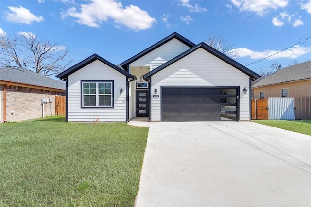 view of front of house with a garage, a front yard, concrete driveway, and fence