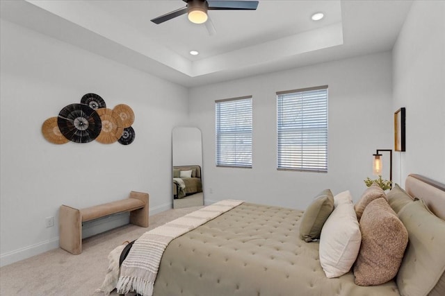 bedroom featuring recessed lighting, carpet, a raised ceiling, and baseboards