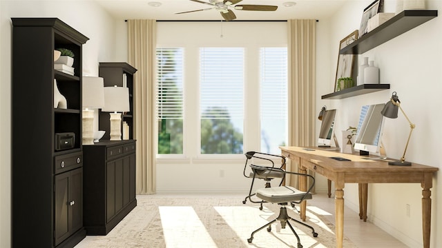 home office featuring a ceiling fan and baseboards