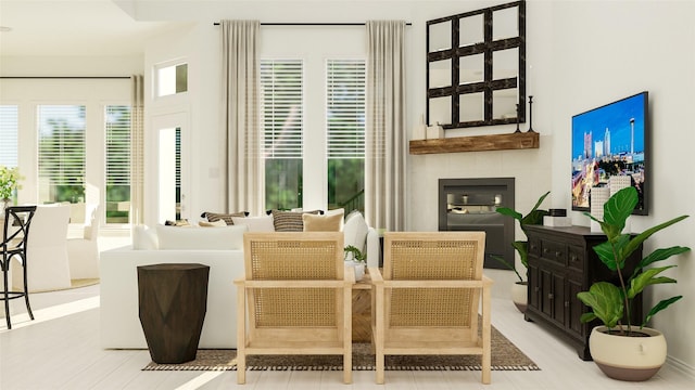 sitting room featuring a glass covered fireplace