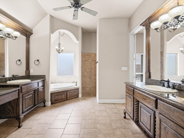 bathroom with ceiling fan with notable chandelier, two vanities, a sink, and tile patterned flooring