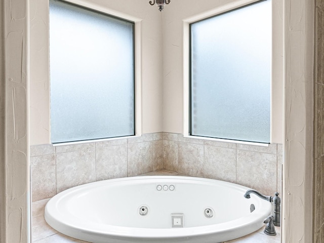 bathroom featuring plenty of natural light and a whirlpool tub