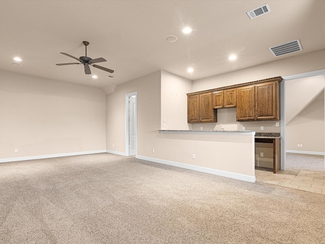 kitchen featuring light carpet, visible vents, and open floor plan