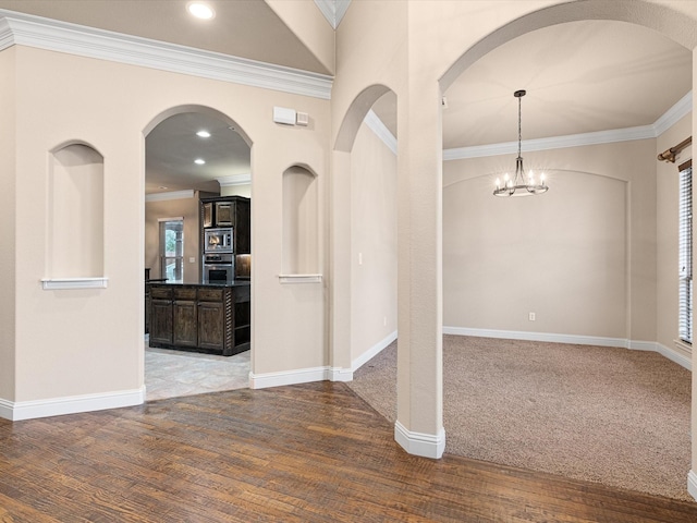 interior space with recessed lighting, a notable chandelier, baseboards, and wood finished floors