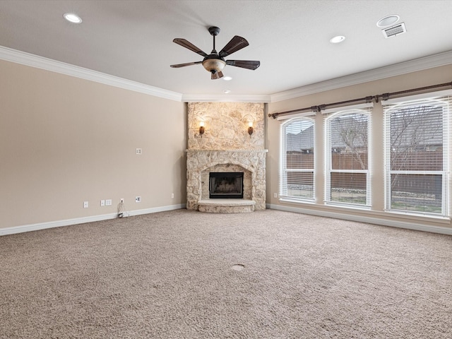 unfurnished living room with a stone fireplace, carpet floors, visible vents, baseboards, and crown molding