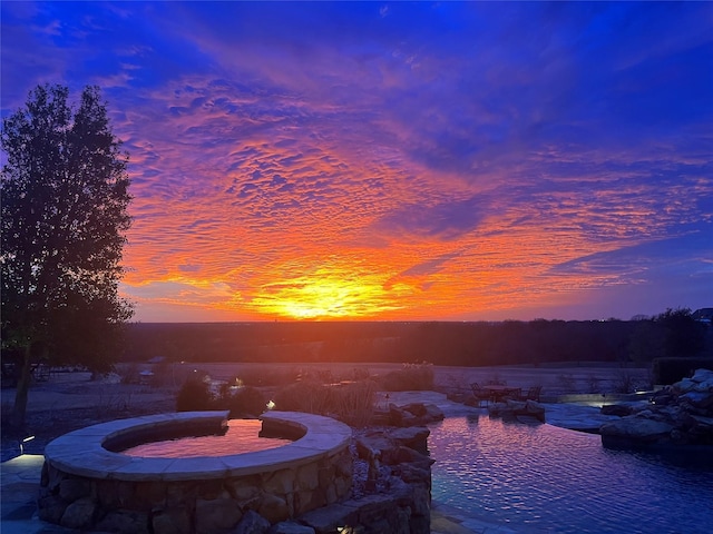 view of pool at dusk