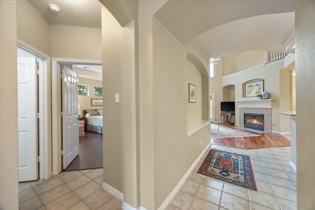 hall with light tile patterned floors and baseboards