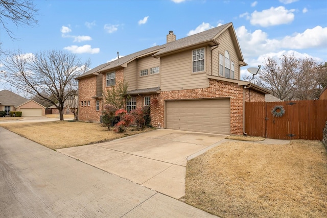 traditional-style home featuring an attached garage, brick siding, fence, driveway, and a chimney