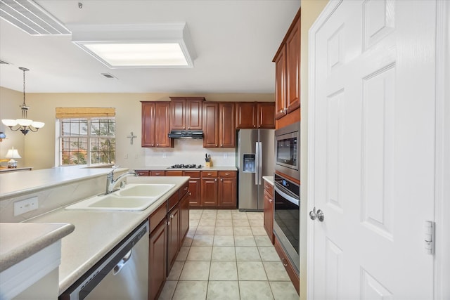 619 Loch View Ct, Rockwall, TX 75087 - kitchen with stainless steel appliances, a sink, light countertops, pendant lighting, and a chandelier