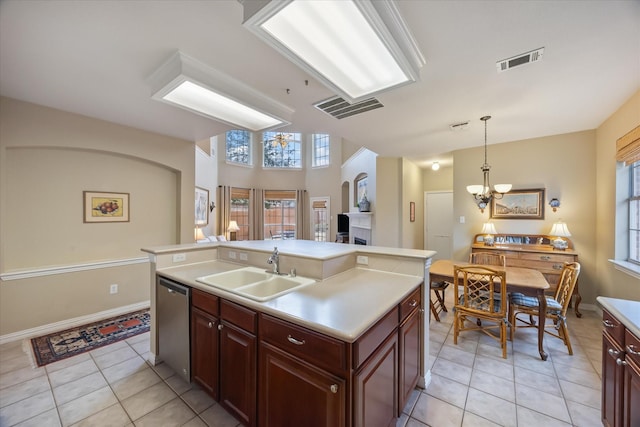 kitchen featuring light countertops, visible vents, stainless steel dishwasher, a kitchen island with sink, and a sink